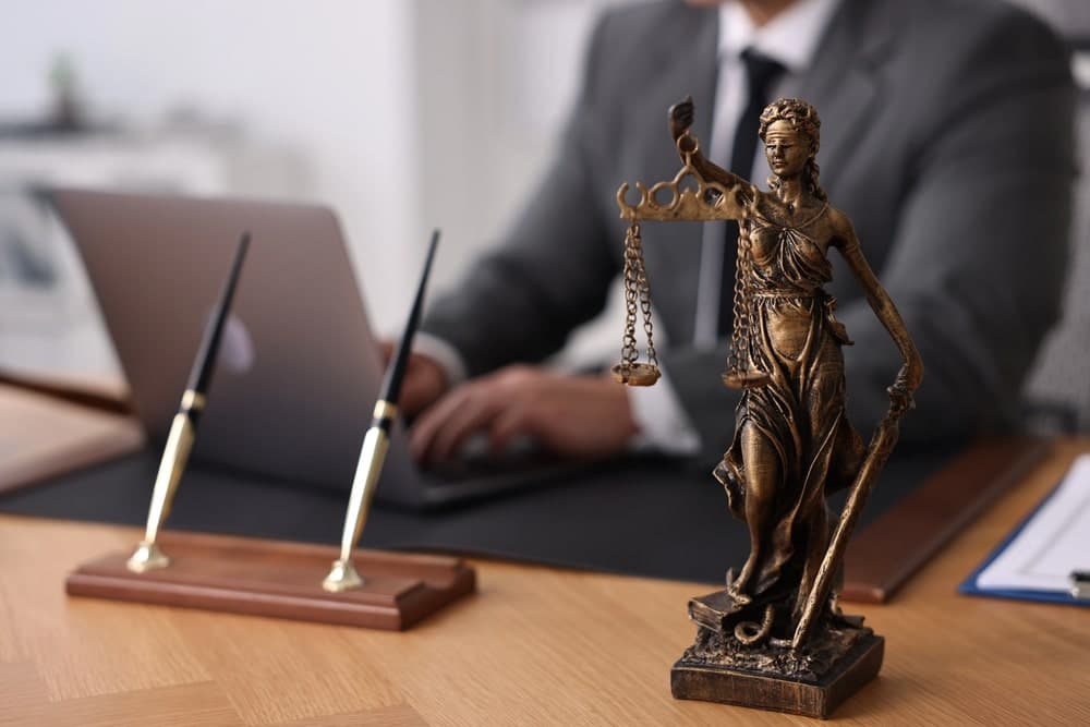 Lawyer reviewing underage drinking laws at office desk.