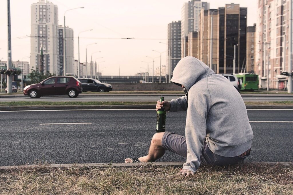 Man drinking on street involved in public intoxication near UT Campus