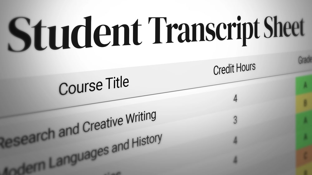 Image shows close up of a student transcript showing course grades and credit hours for academic performance review